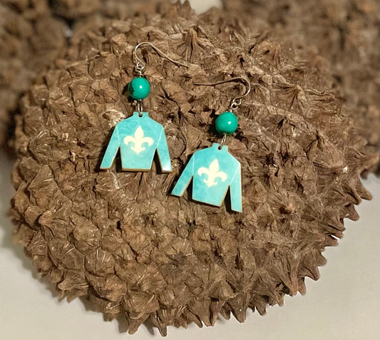 A pair of teal blue silk derby earrings with a tagua nut and acai seed design