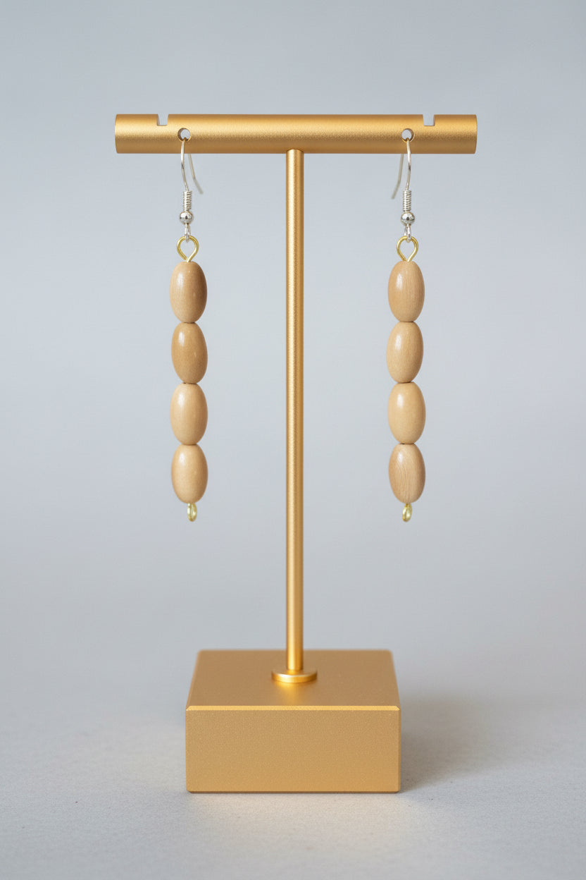 A pair of beige tagua nut dangle earrings with gold accents autumn spring
